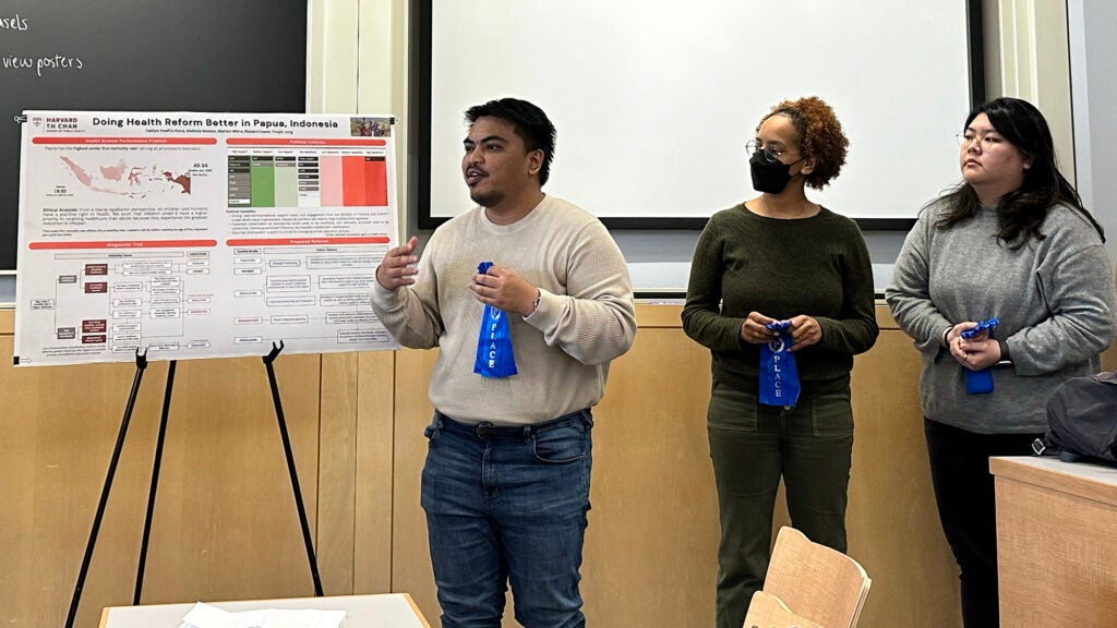 Richard Kowel and teammates hold blue ribbons after winning first place for their project