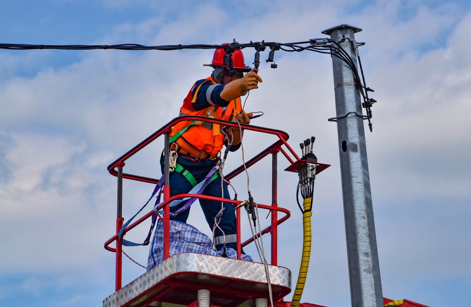 Electrician repairing a power line