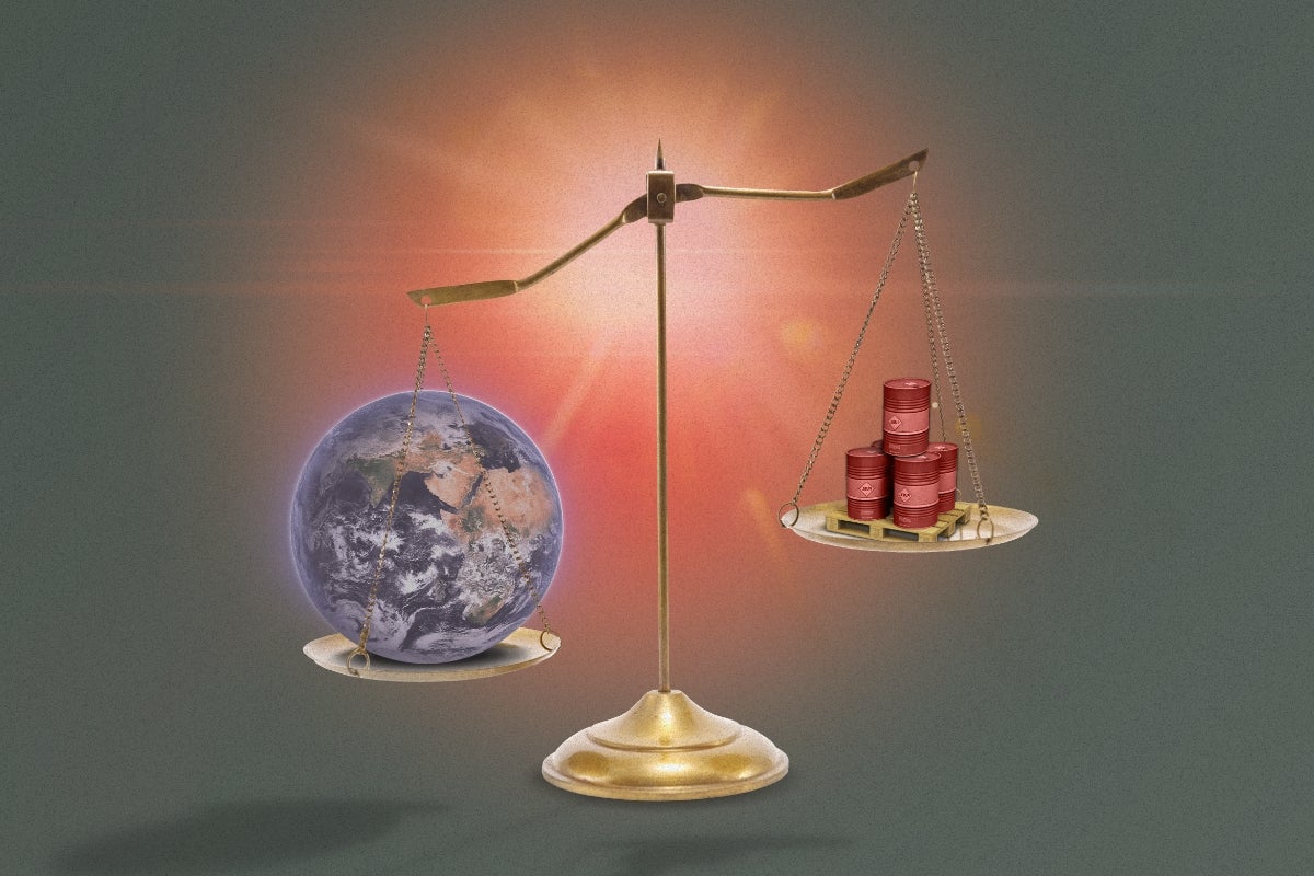 A scale balancing the globe and barrels of oil