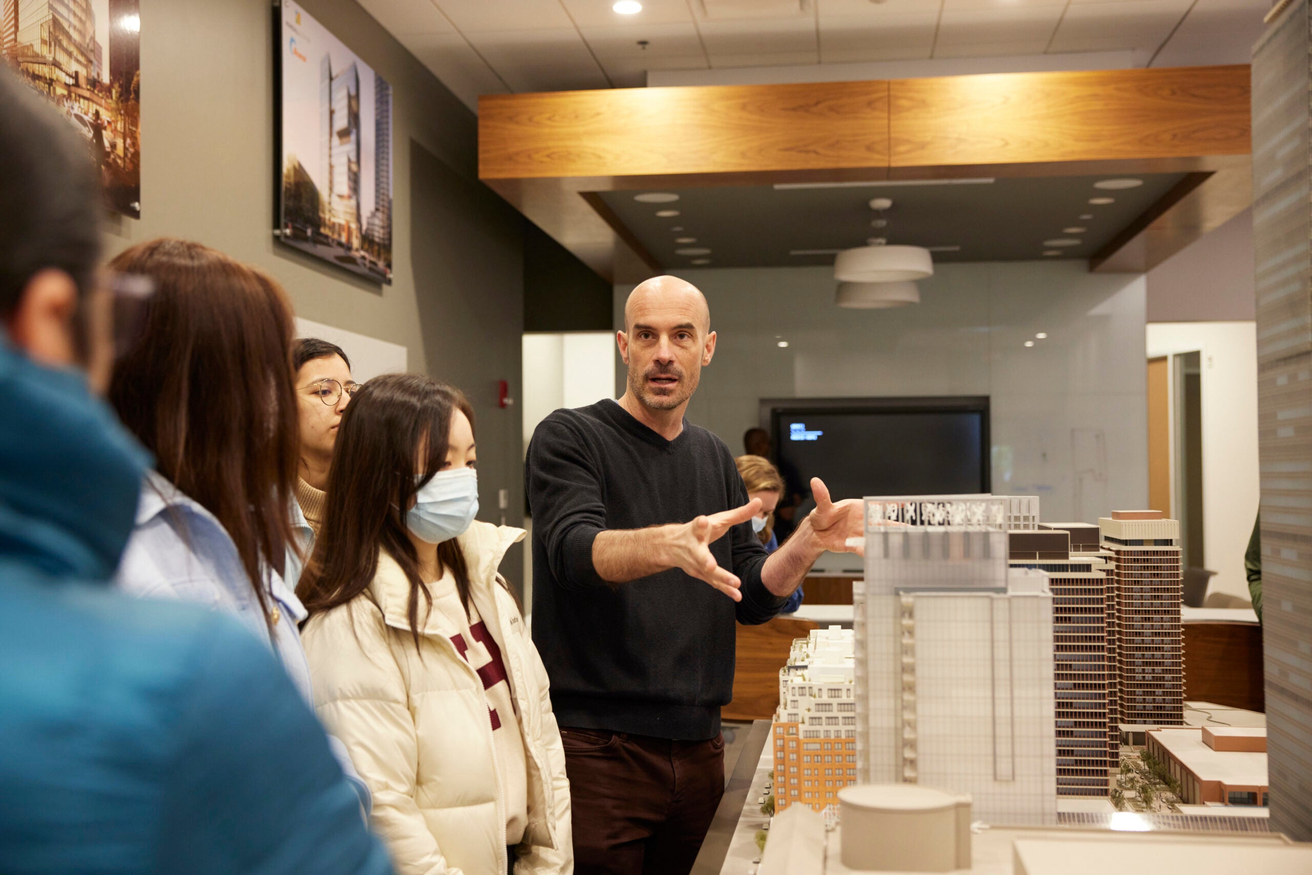 Dr. Allen and students looking at building models.