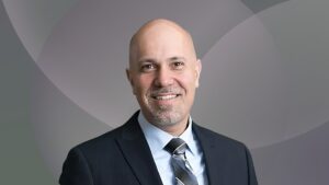 Headshot of Nir Menachemi. He is wearing a suit and tie and smiling.