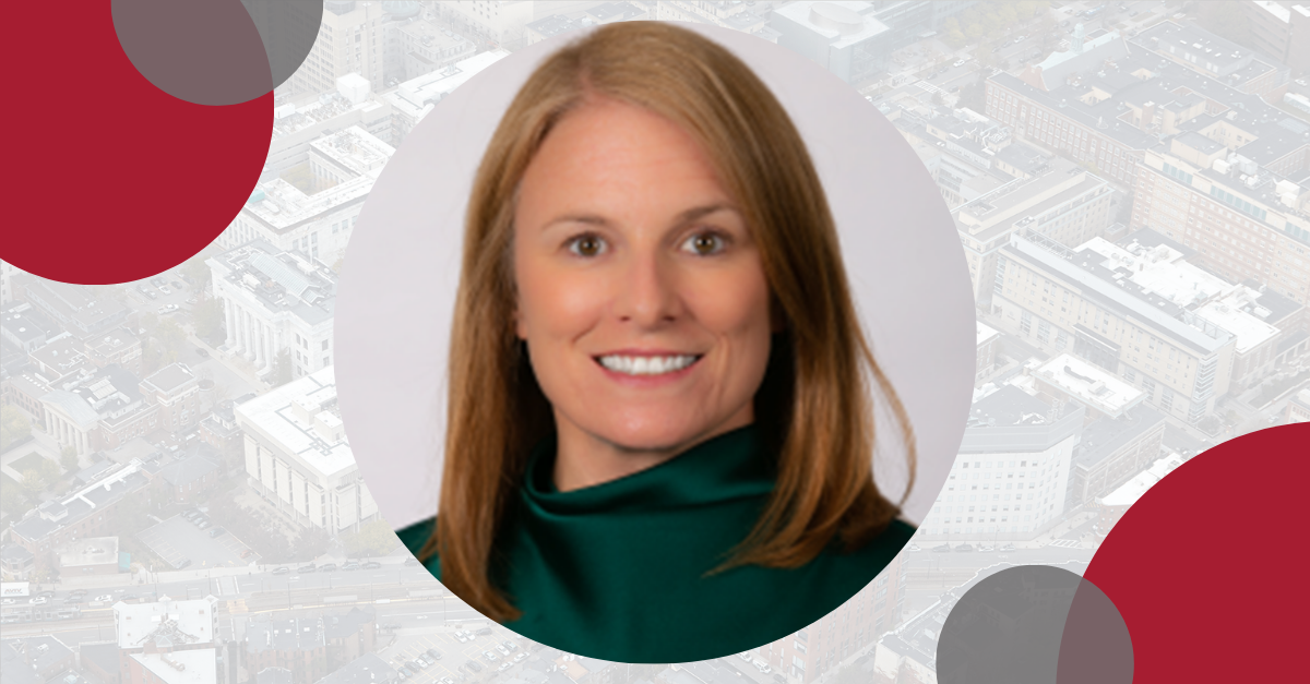 Headshot of Maureen Hensley-Quinn against a backdrop of the Boston skyline