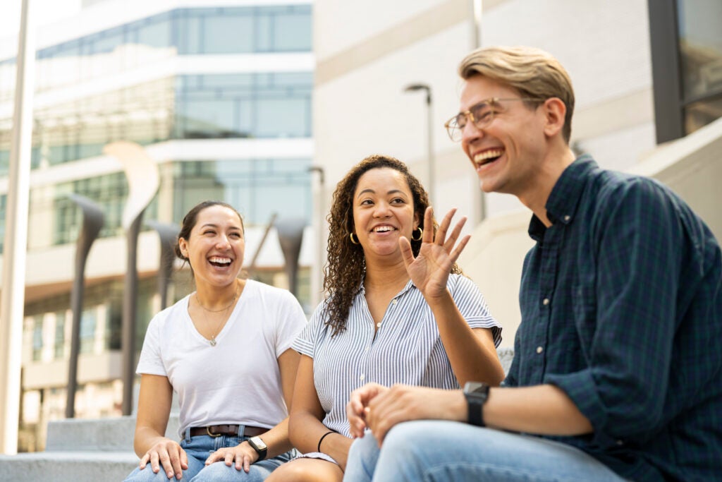 Three students enjoy a break outside. 