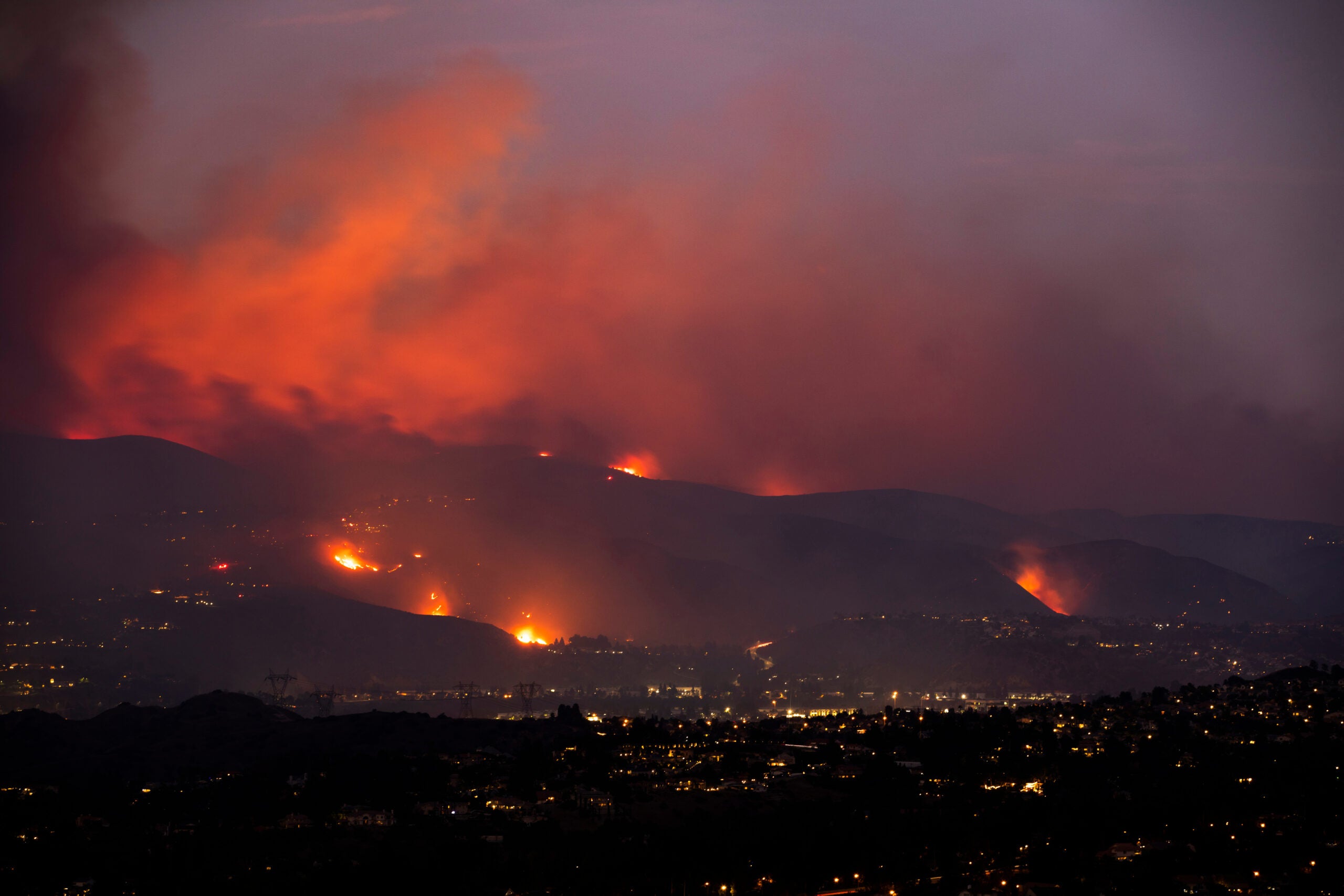 A wildfire tears through the hills of California