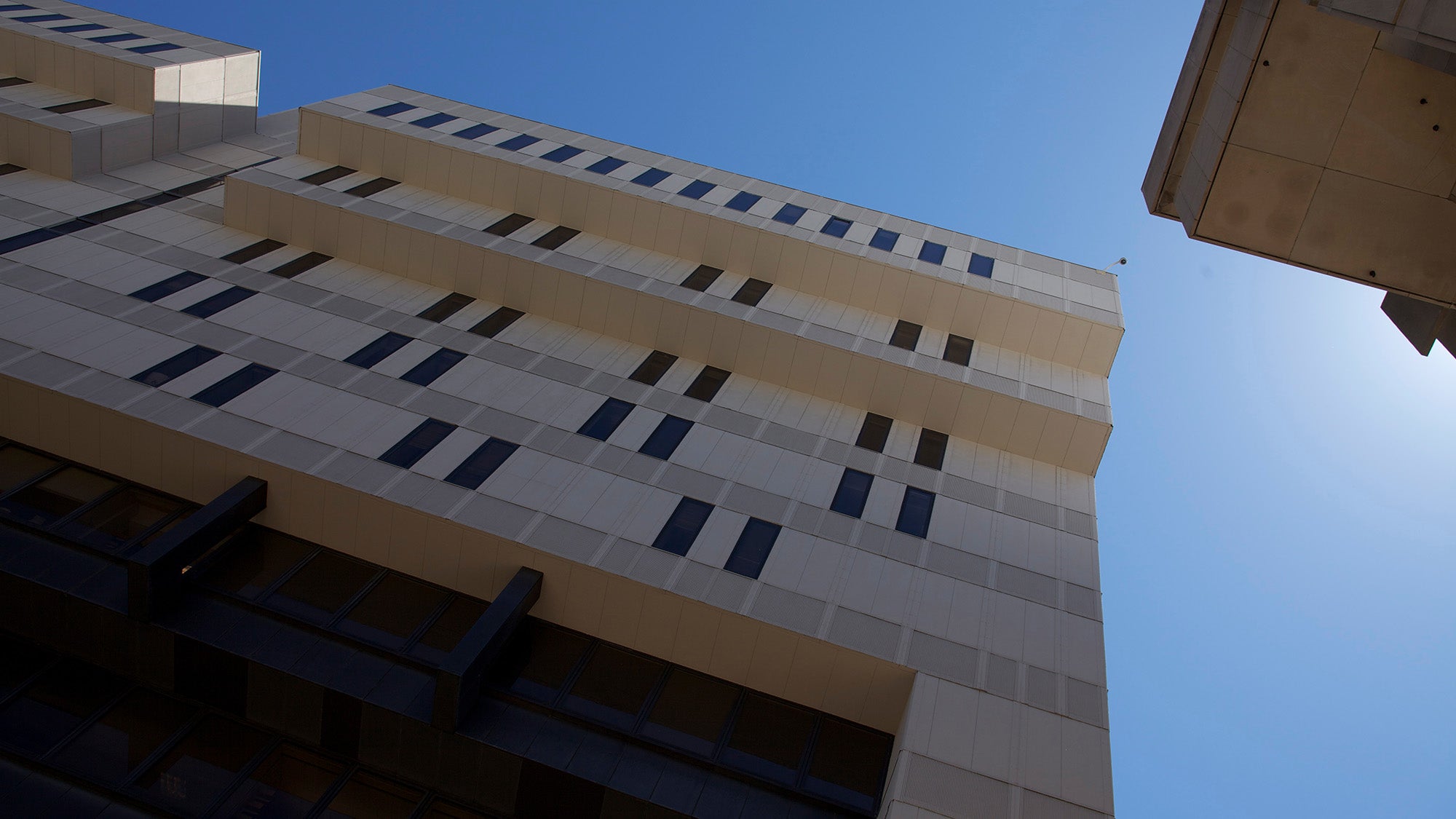 Kresge building, looking up against blue sky