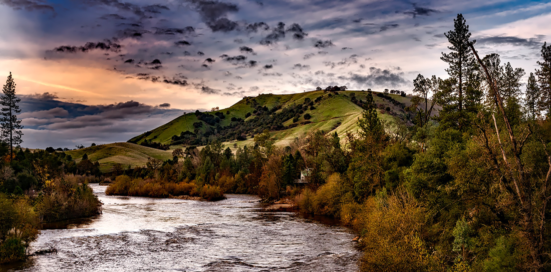 A river with mountains in the distance