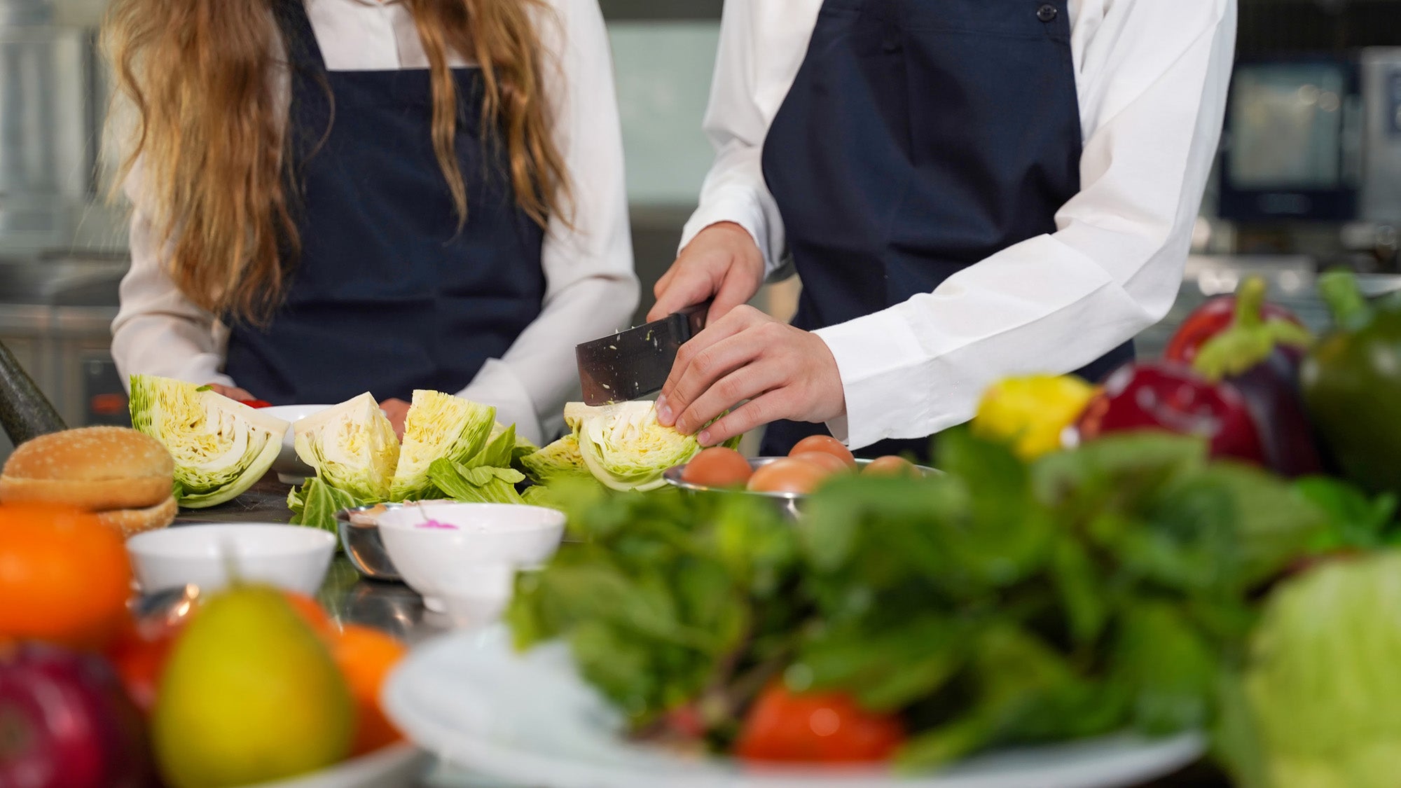 A chef demonstrates how to chop fresh vegetables.