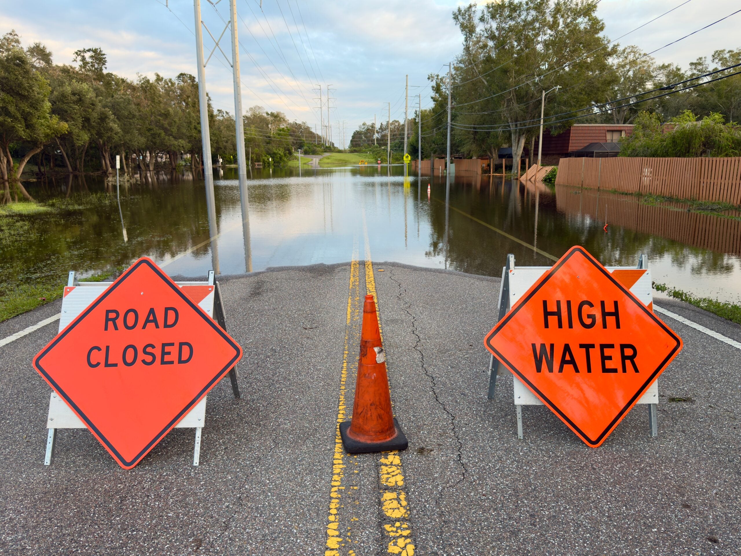 Road Closed and High Water sign on Florida street flooded by a tropical storm.