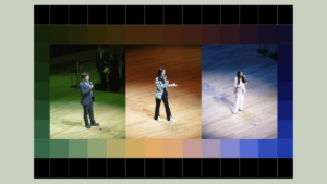 grid of three speakers on a stage holding microphones standing up