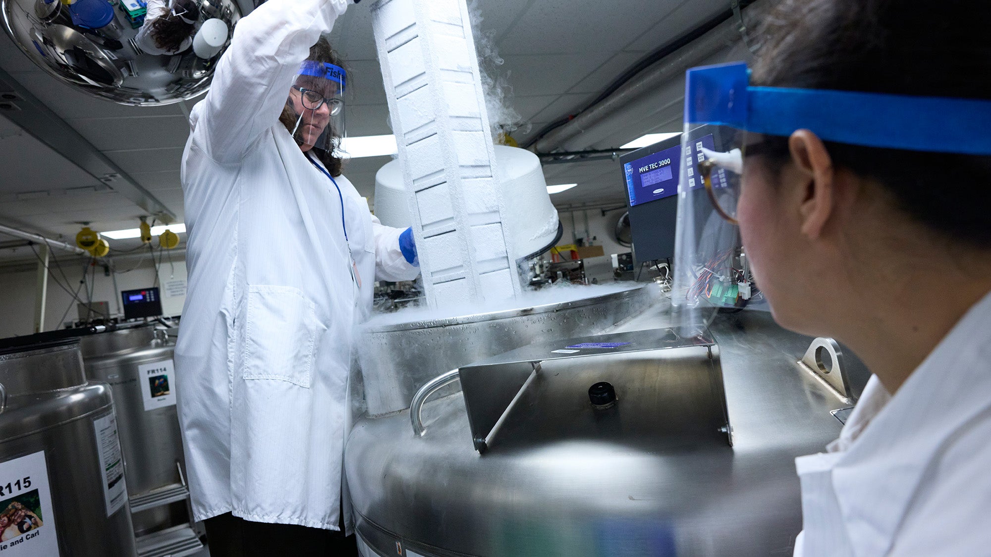 Lab workers handle biological samples