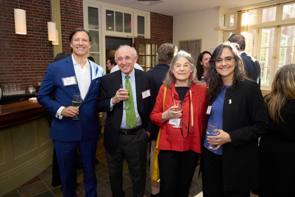 Four guests pose together. 