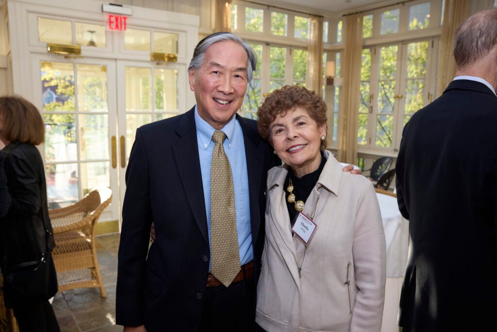 Two guests pose with arms around one another. 