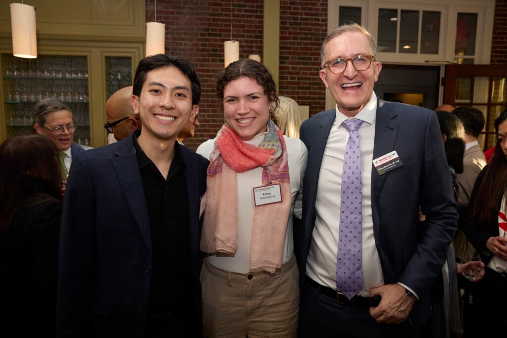 Dean Baccarelli poses with two guests. 