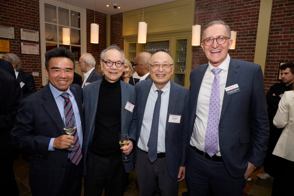 A group of four guests pose together, with Dean Baccarelli at right and Gerald Chan next to him. 