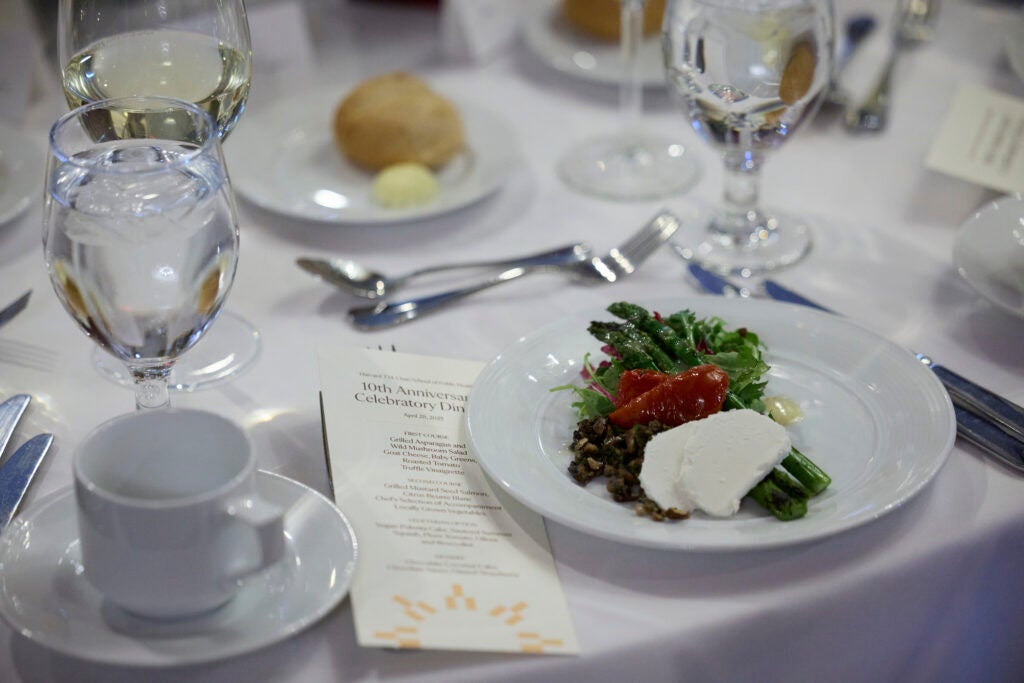 A  place setting of bread and salad are ready to be enjoyed. 