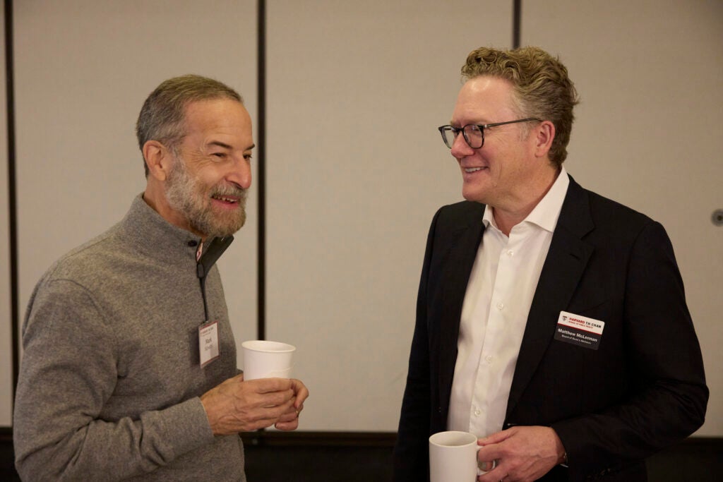 Two guests chat over coffee