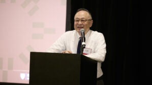 Gerald Chan speaking at a podium