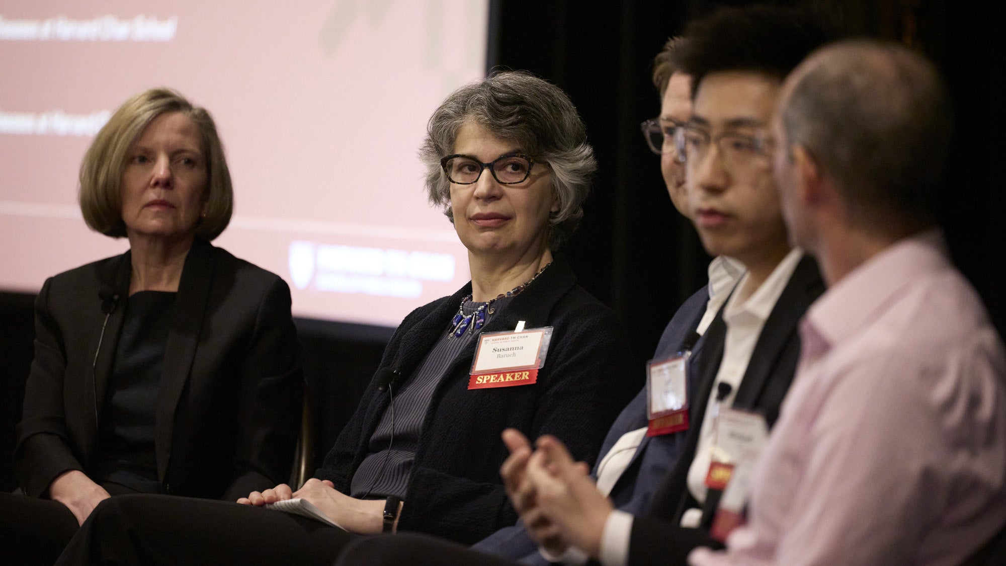 A member of the panel speaks while other panelists look on.