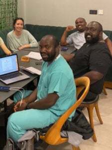 Four people sitting around a conference table.