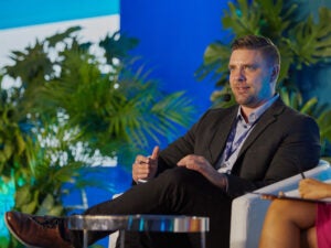 Kevin Linn speaking from a conference stage.