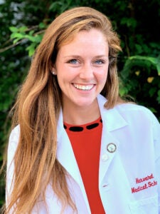Logan Beyer wearing her medical school white coat.