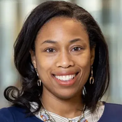 Headshot of Cassandra Pierre. She is smiling and wearing a blue top.