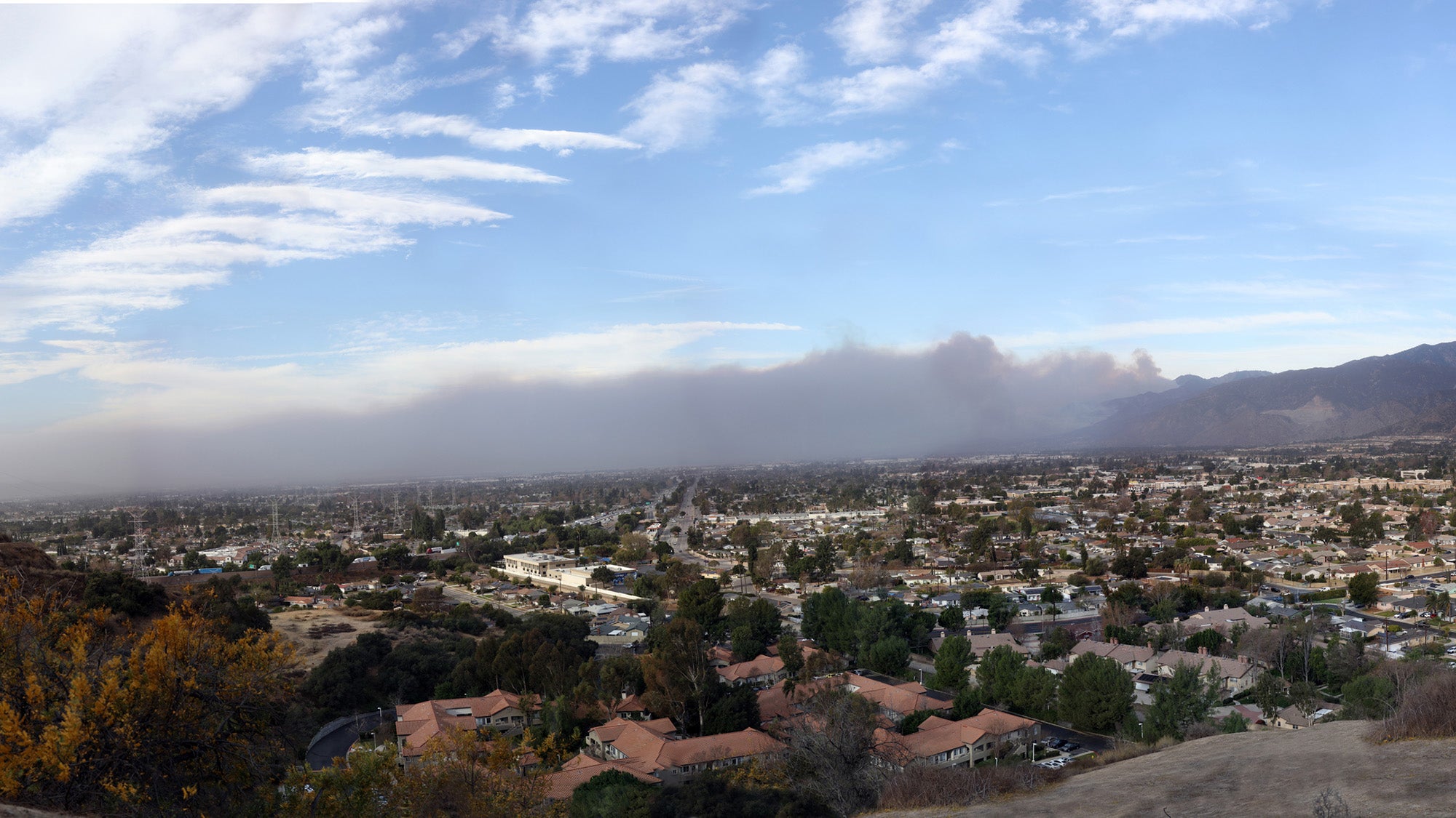 Windblown smoke from January 2025 Eaton wildfire seen stretching across from the slopes of the San Gabriel Mountains toward the sea.