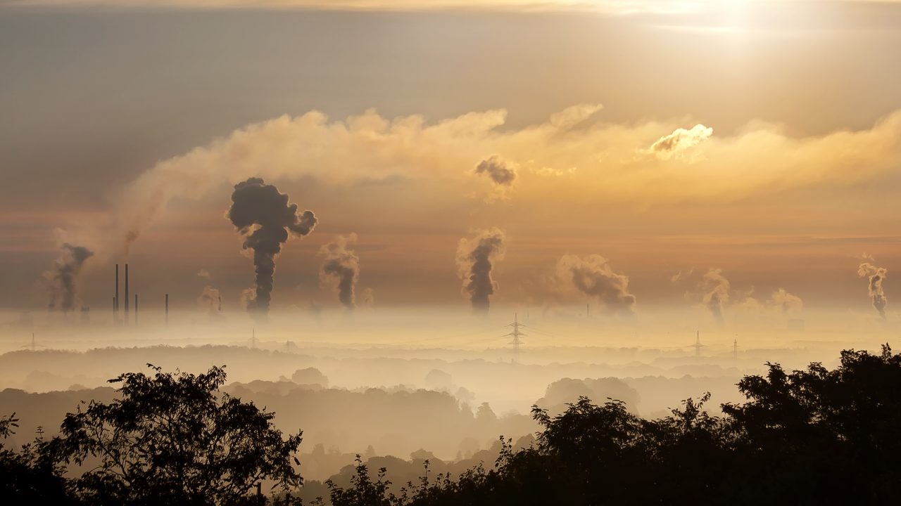 Haze and pollution with smokestacks in the distance