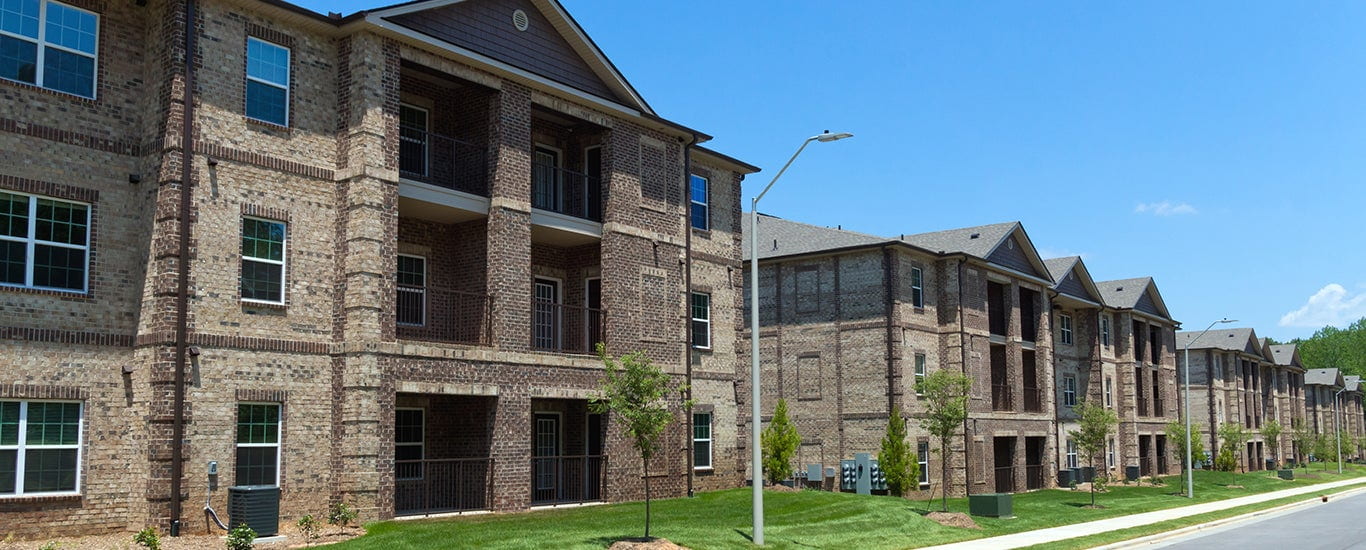 Building Success hero image showing apartment complex