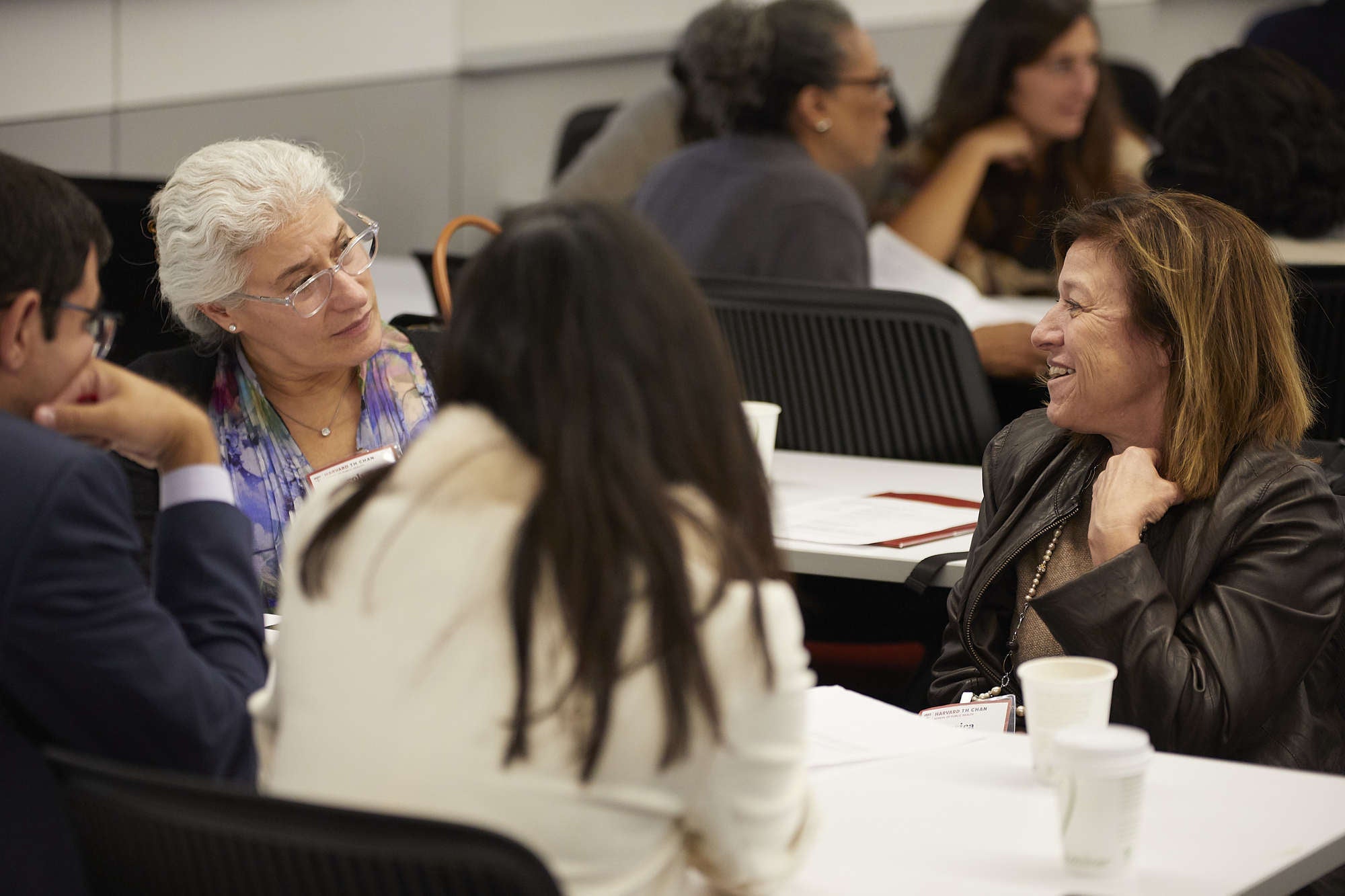 Participants in the annual alumni conference interact between workshops