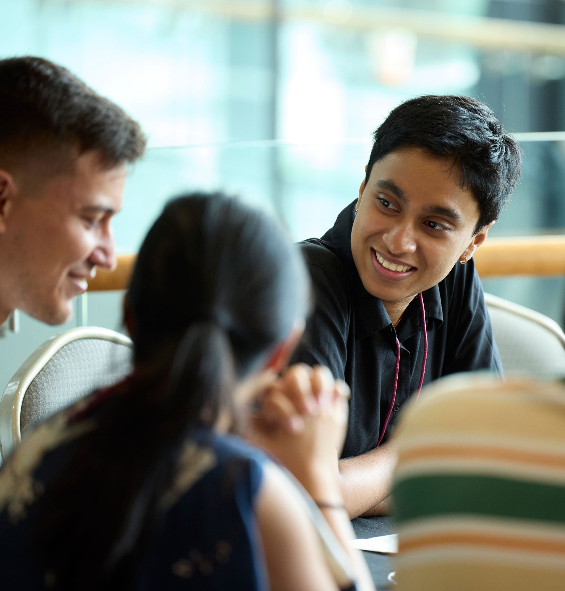 Students talk to each other around a table at orientation