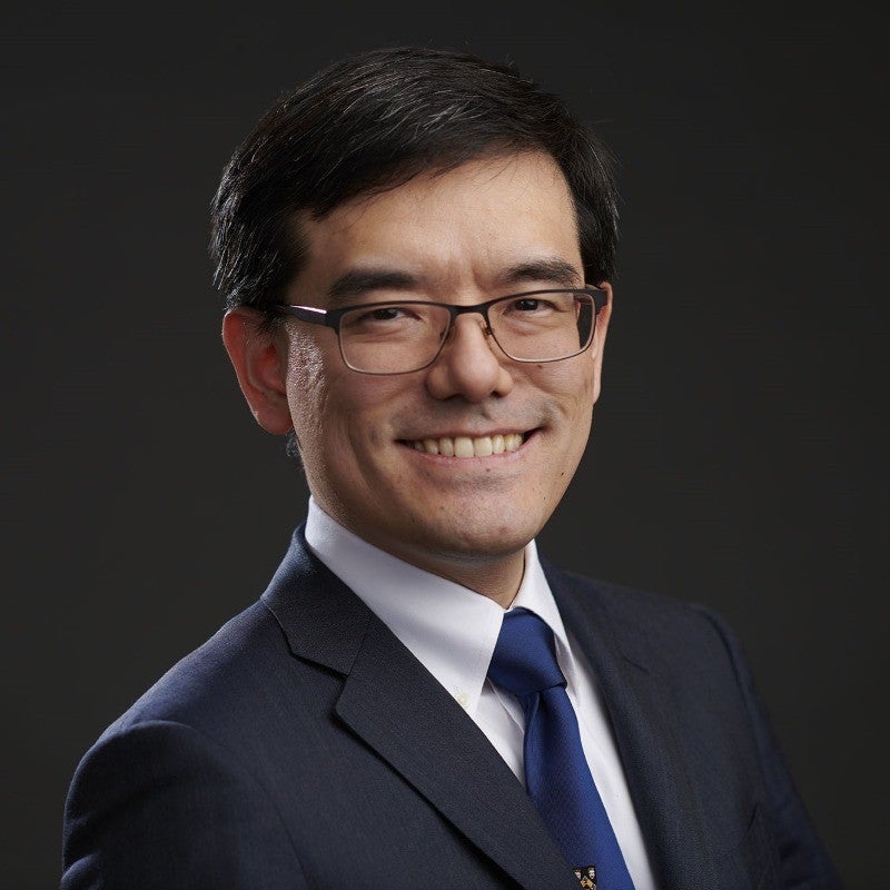 Headshot of Daichi Hayashi. He is smiling and wearing glasses and a suit.