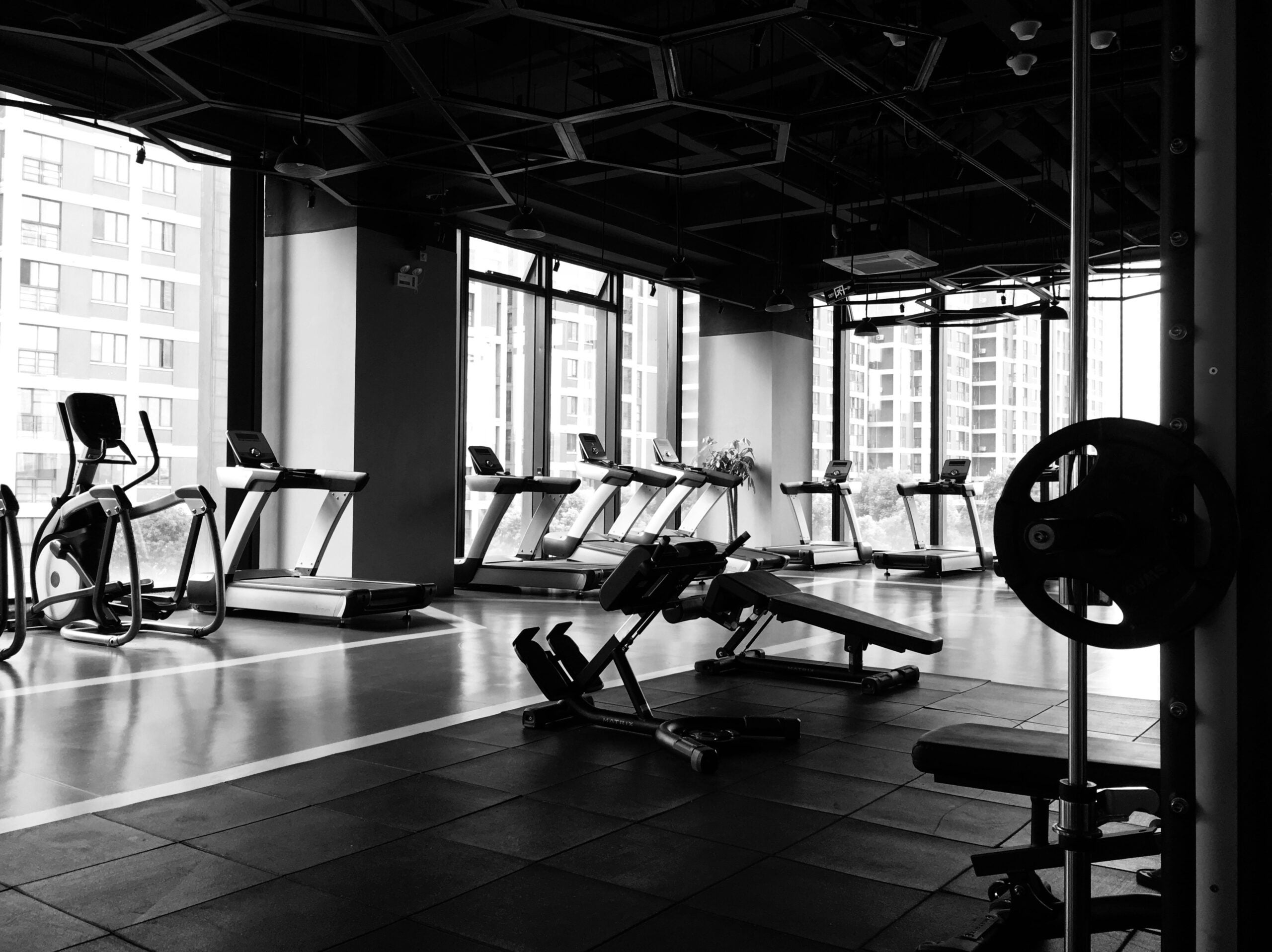 A black and white image of a gym with equipment