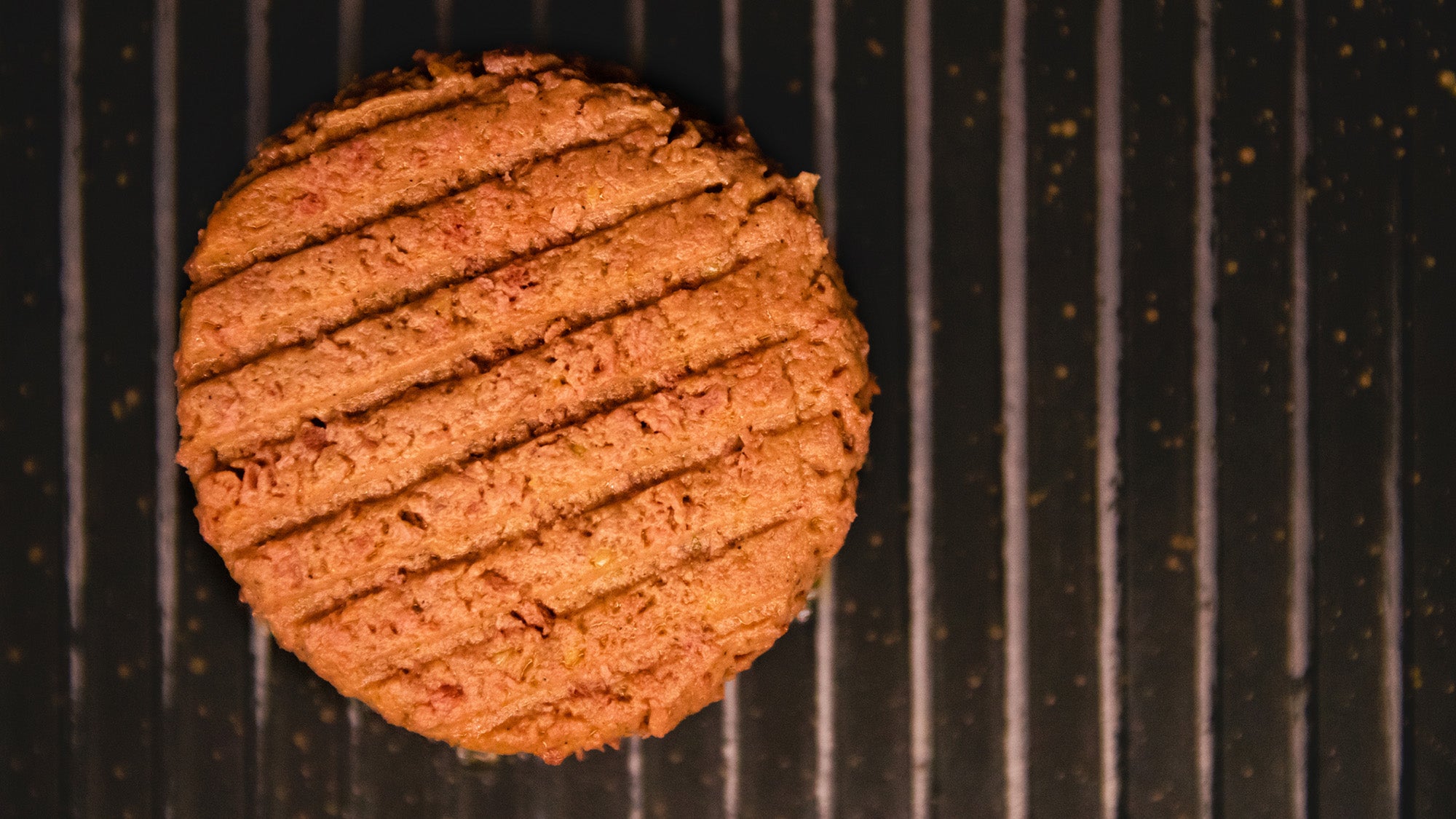A vegan hamburger patty on the grill