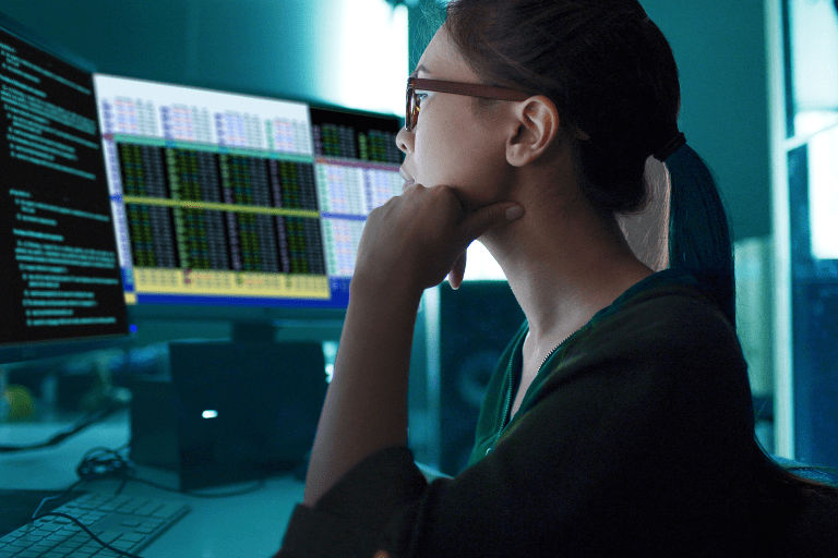 Woman looking at computer screens
