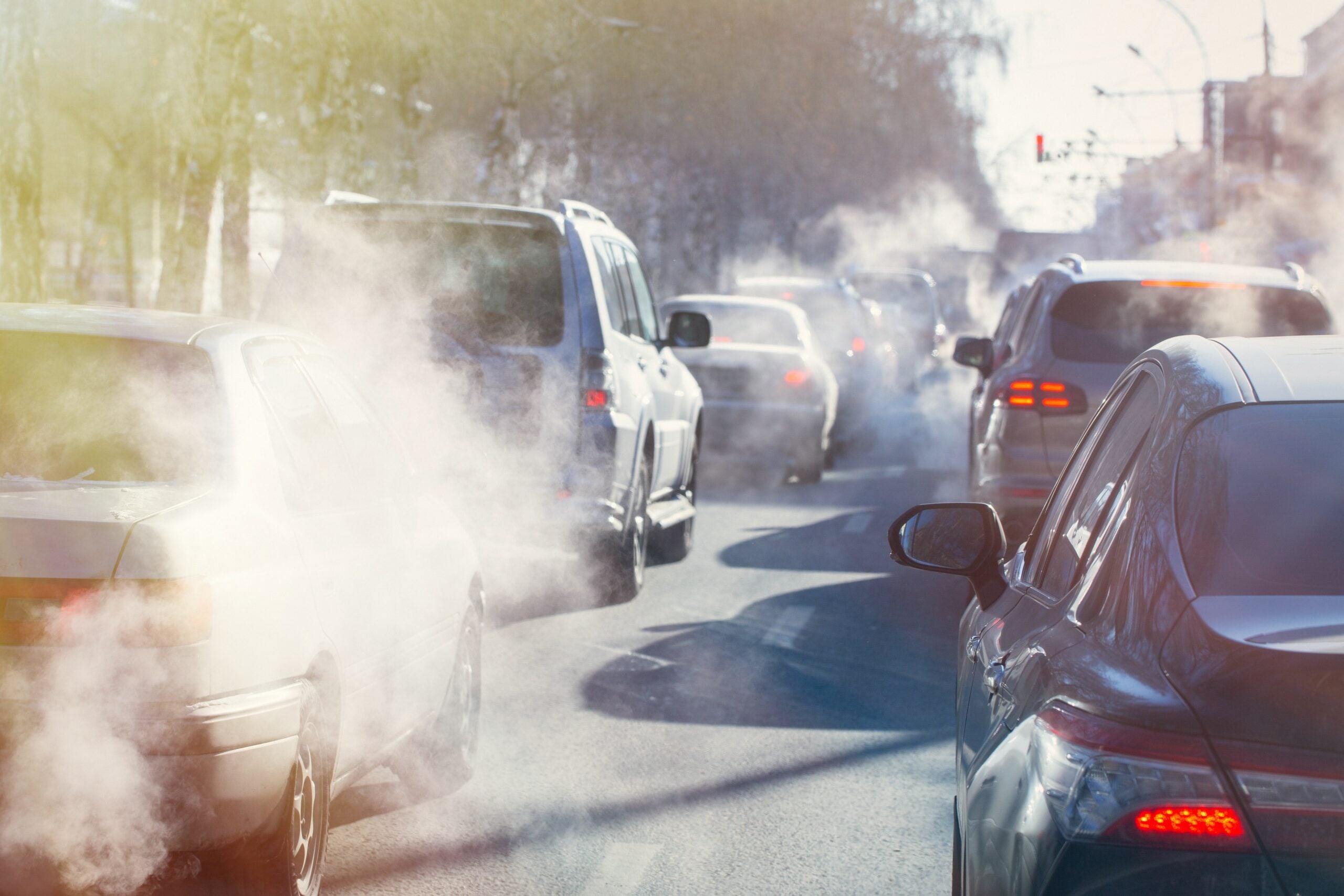 pollution from the exhaust of cars in the city in the winter. Smoke from cars on a cold winter day