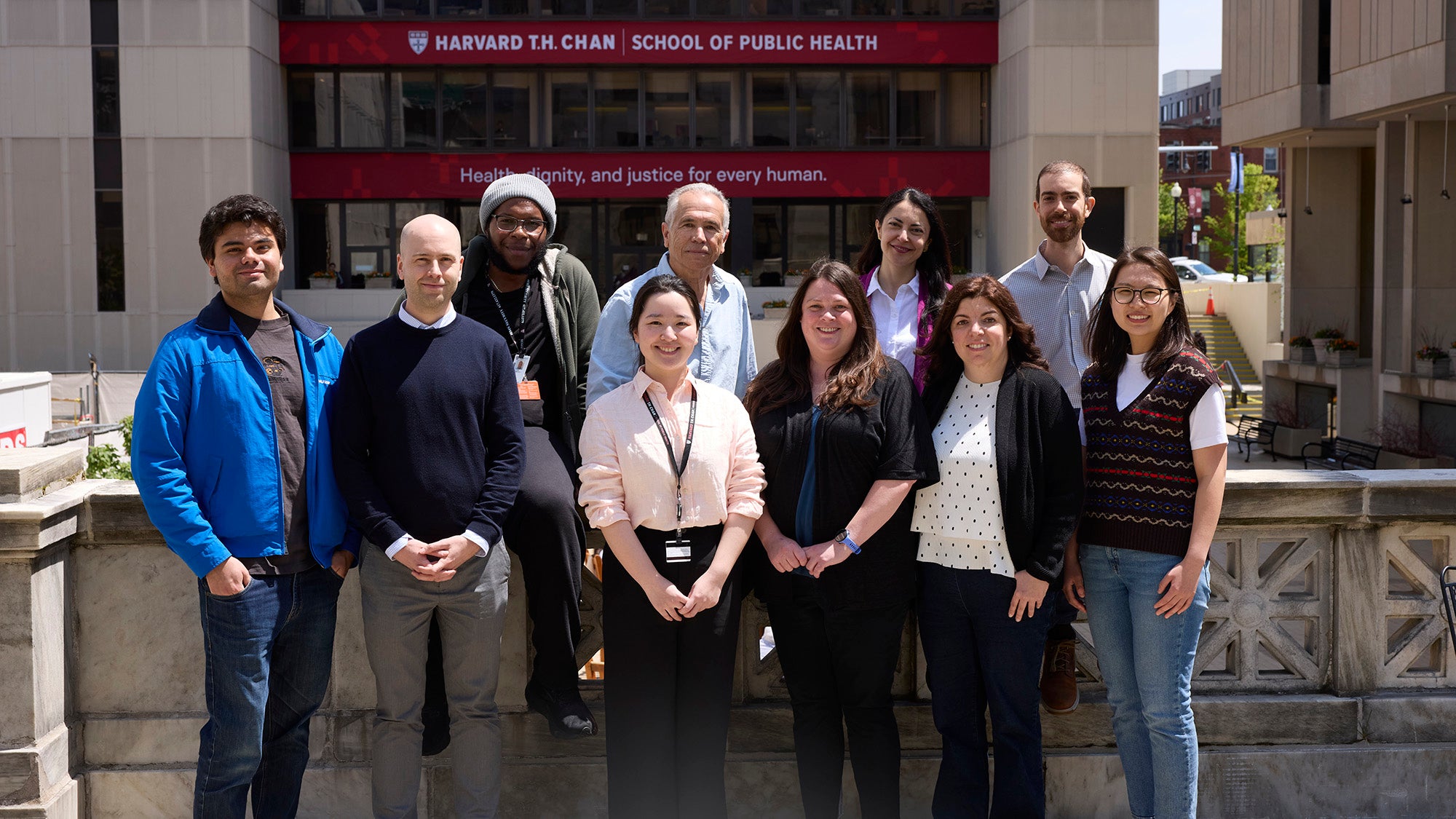 Alberto Ascherio lab team poses for a group photo outside the main entrance of Harvard Can School