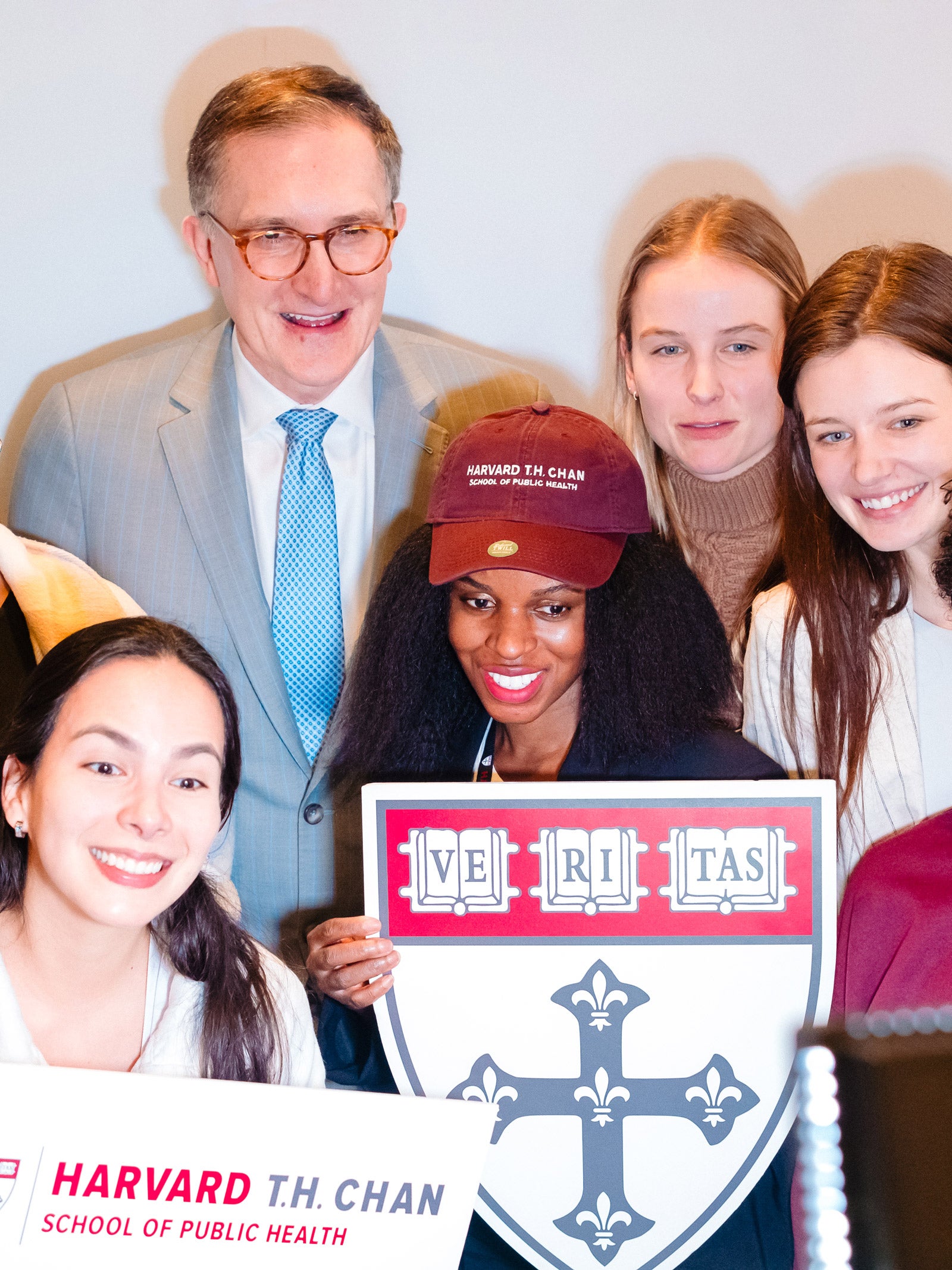 Dean Baccerreli and students gather in front of a HSPH photo booth. 