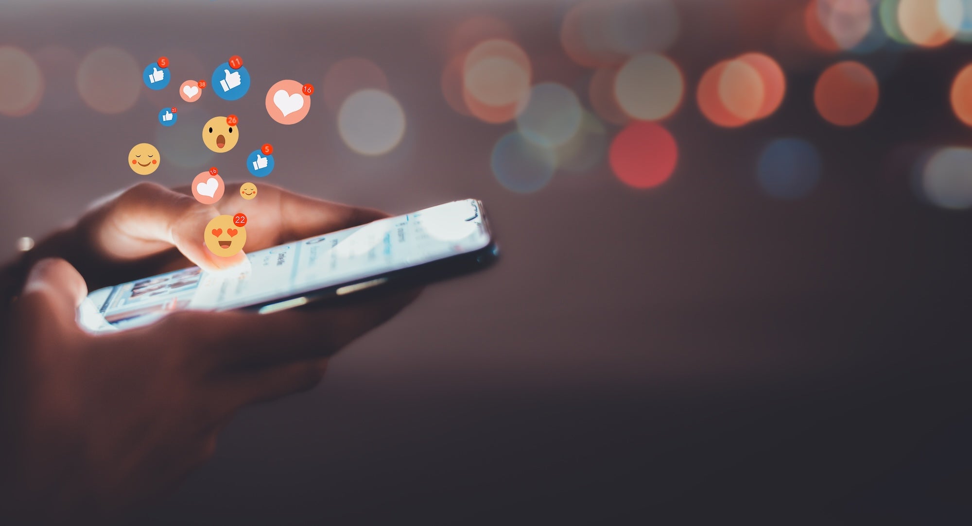 Phone with social media icons rising out of it