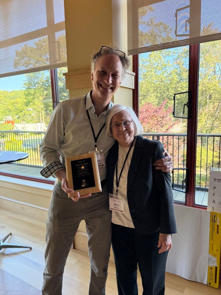 Center Director Dr. Marc Weisskopf presents a plaque to CEC Director of Community Engagement Ann Backus.