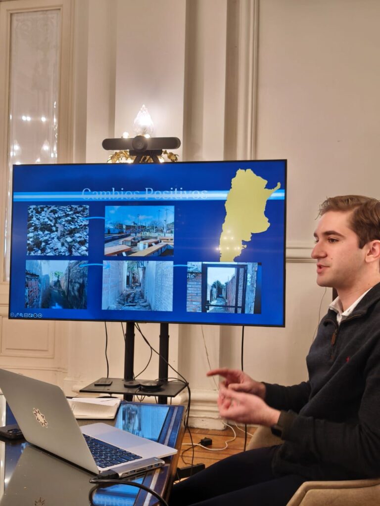 Gene Pozas in front of presentation screen