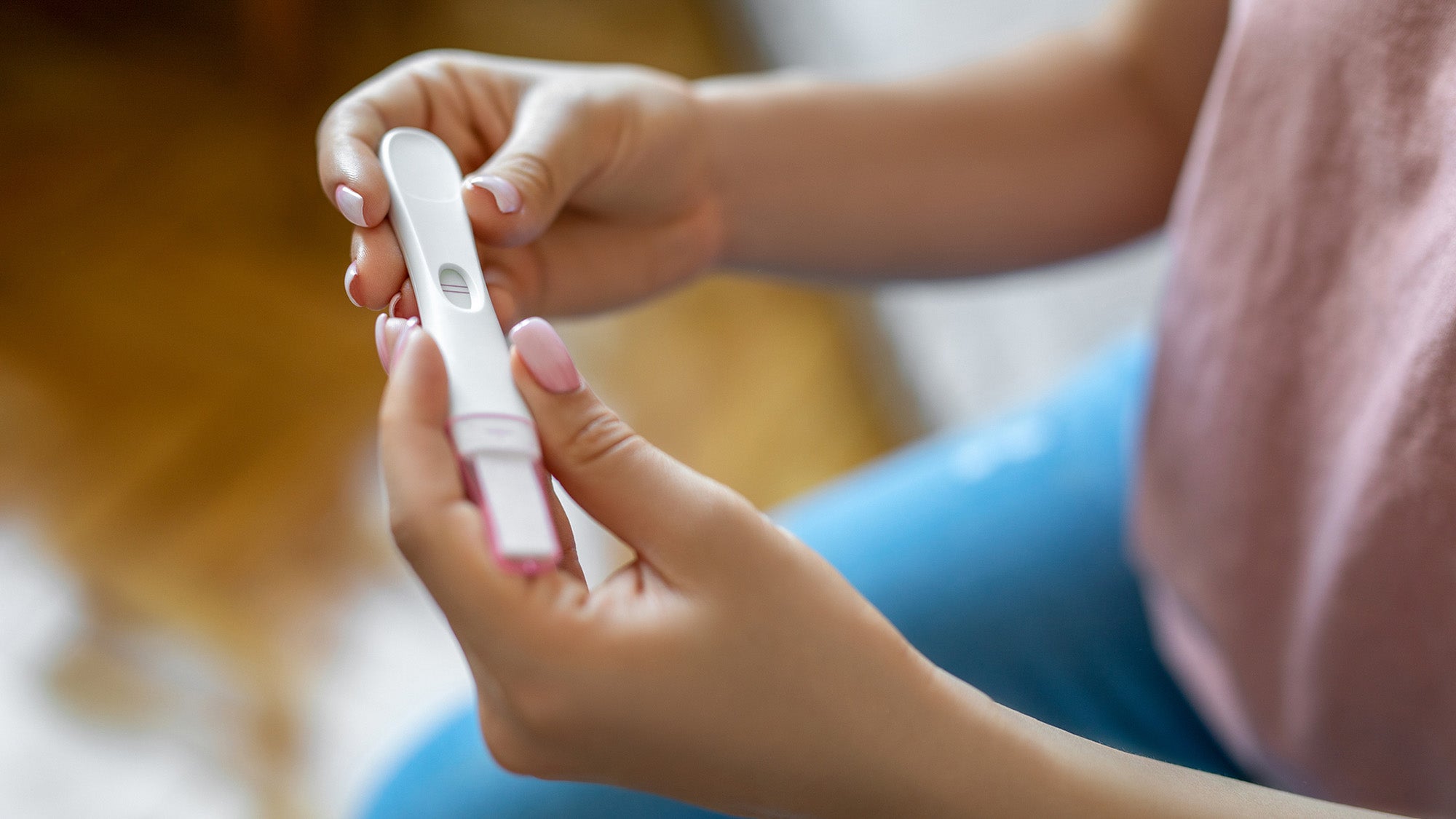 Woman holding pregnancy test