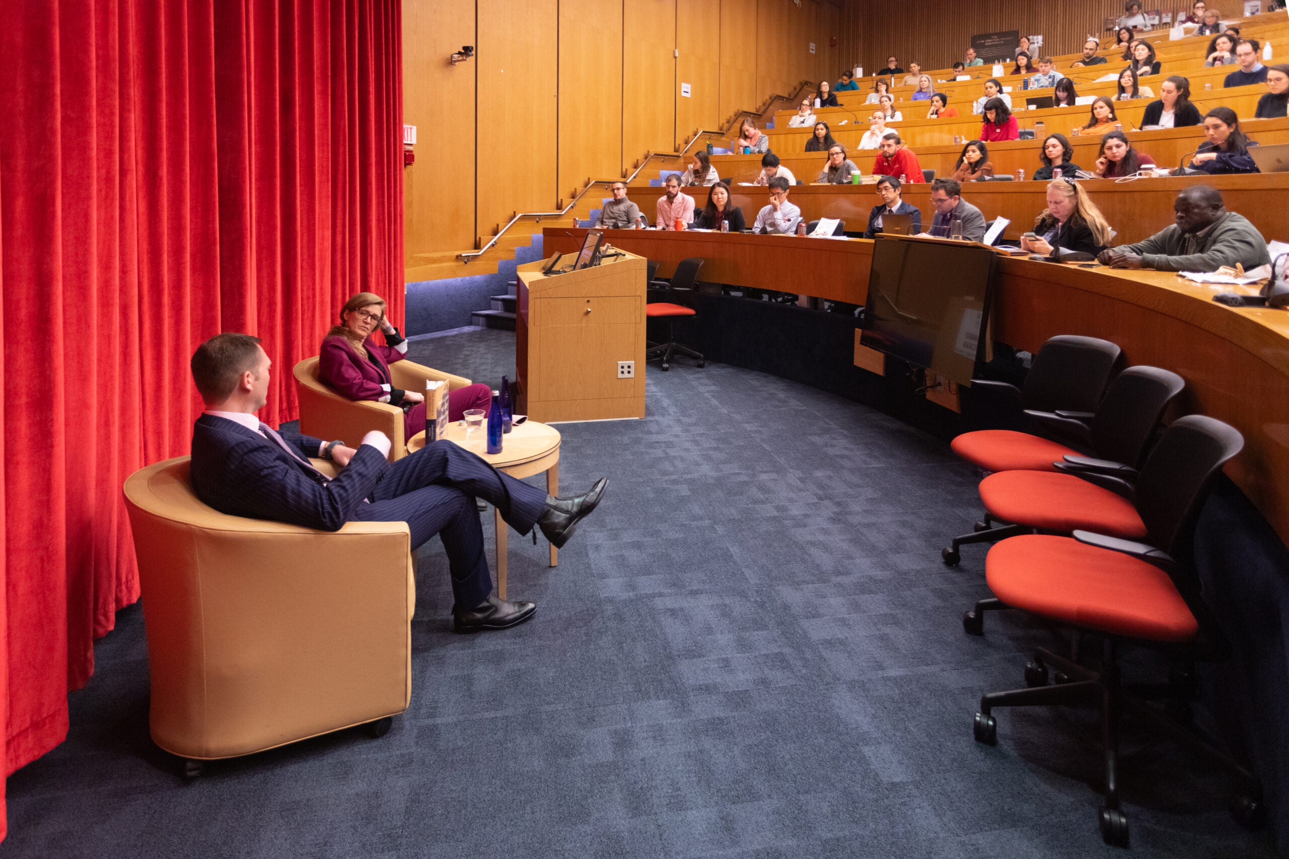 Samantha Power participates in a presentation to a packed auditorium.