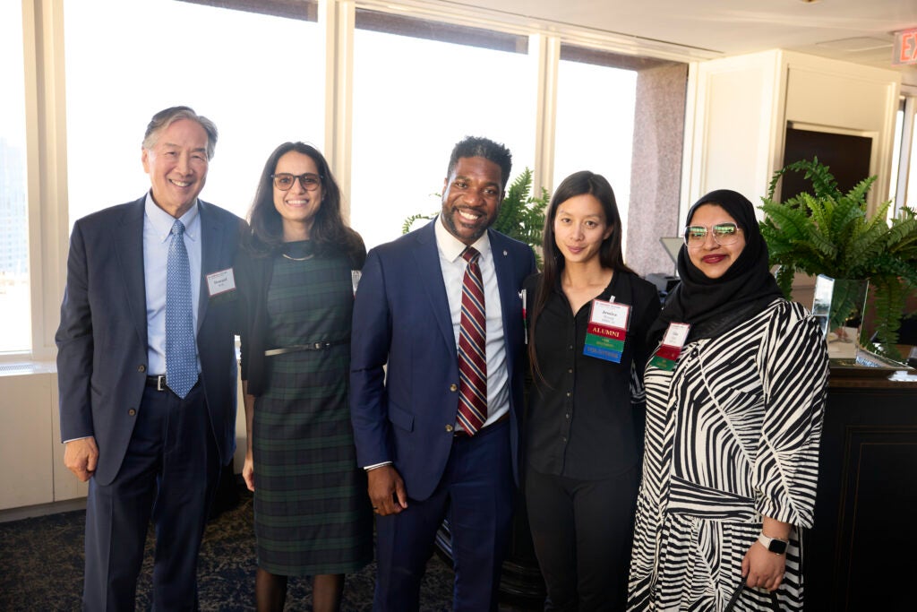 Professor Howard Koh poses with a group of alumni.