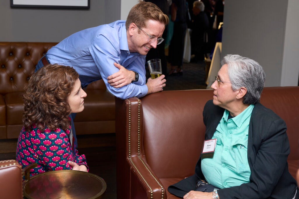 Nancy Krieger talking with emerging professional health professional awardee Morissa Henn, and Morissa's husband. 