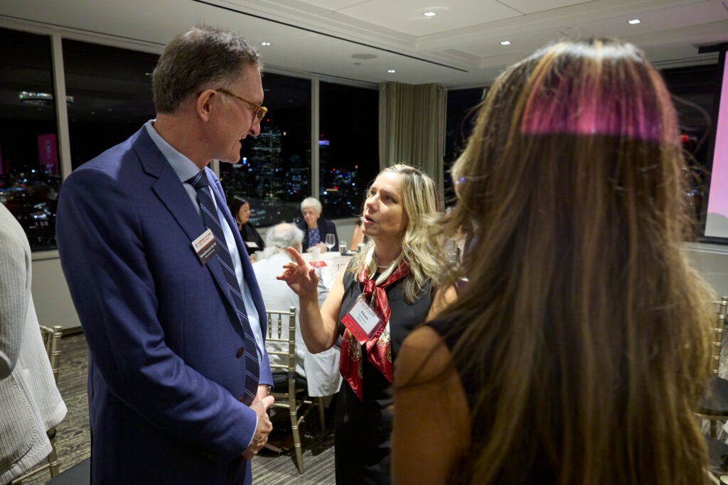 Dean Andrea Baccarelli conversing with alumni. 