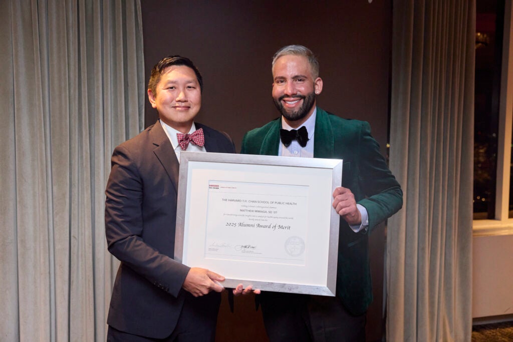Incoming Alumni Association President Bernie Lee presents Matthew Mimiaga with the Alumni Award of Merit.