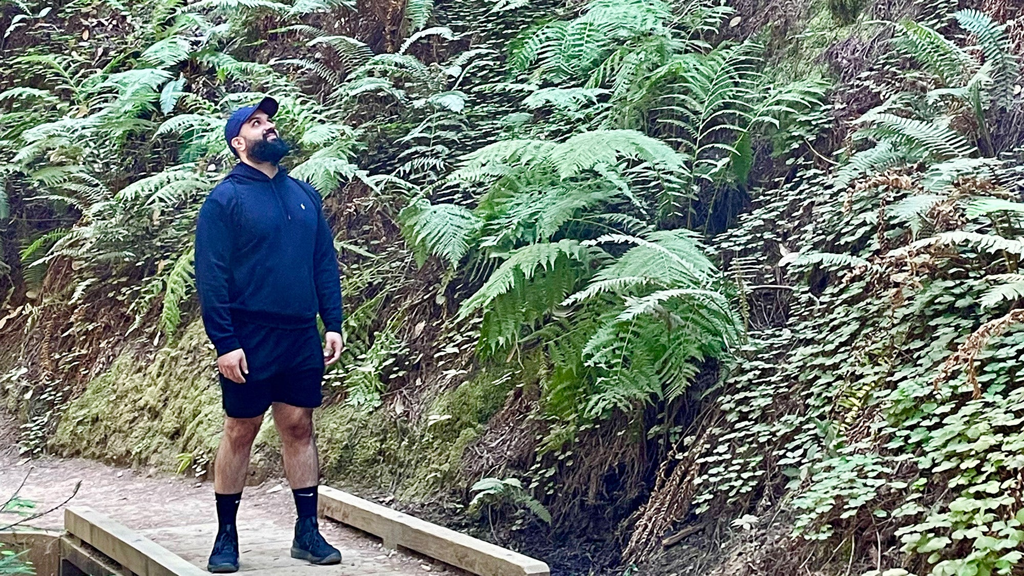 Alan Hernandez Gutierrez crossing a bridge in a wooded area