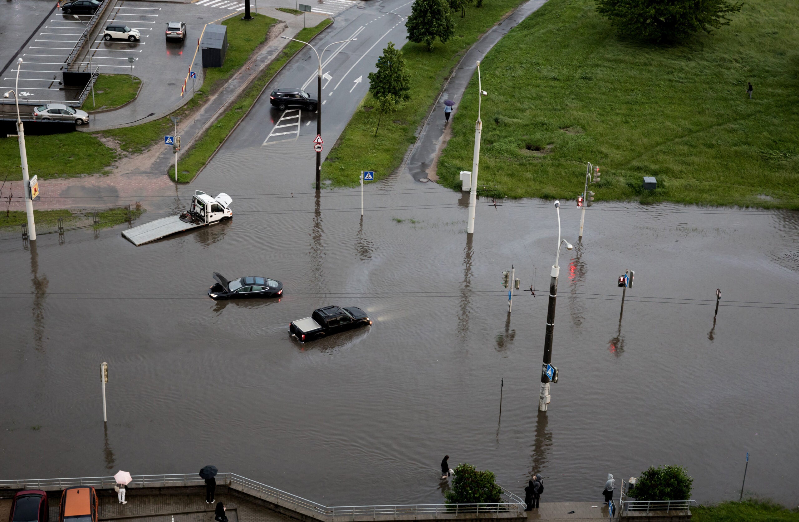 Aerial view of cars driving on flooded road