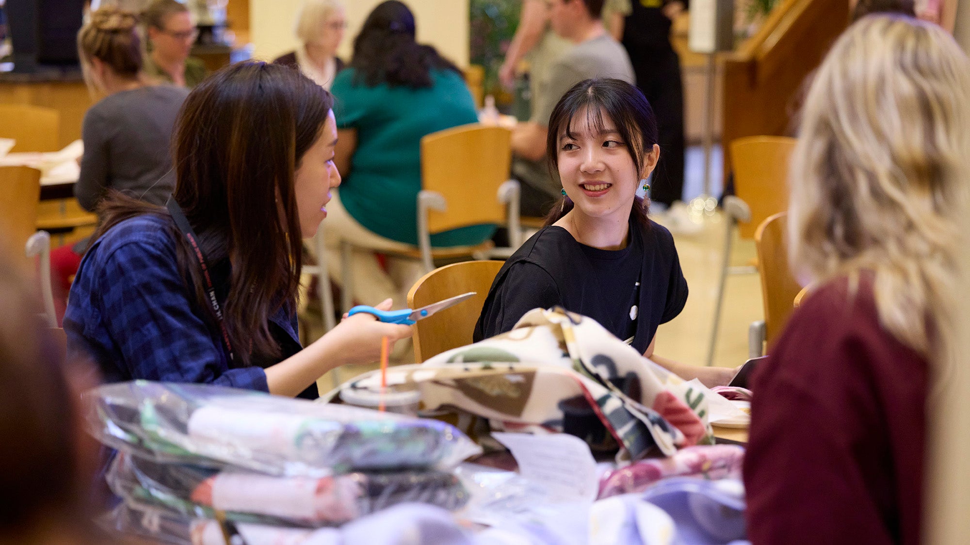Eihi Yoshinaga, a master of science candidate in epidemiology, at the blanket-making table during Harvard Chan School's Day of Service